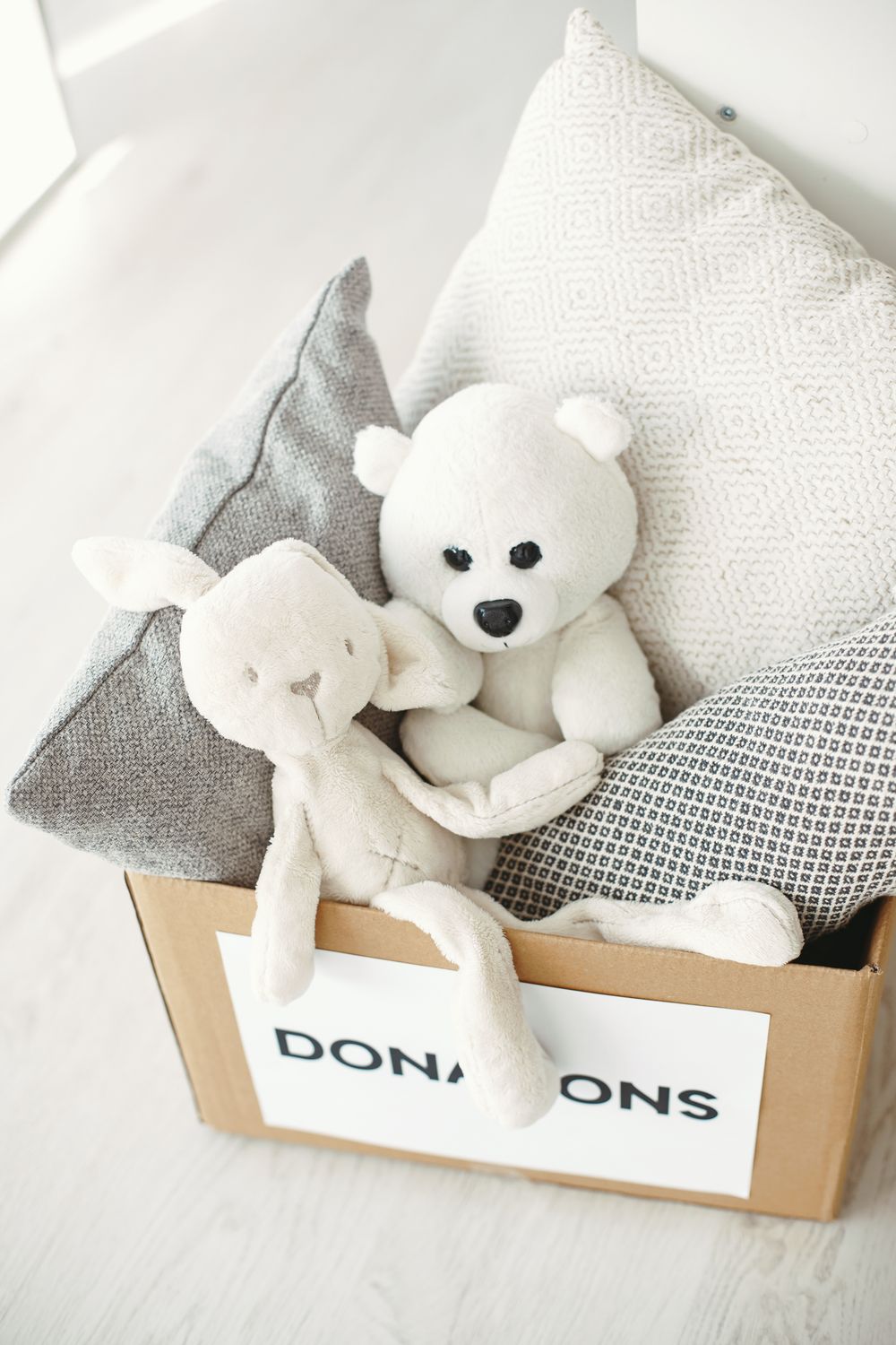 A donation box filled with pillows and stuffed animals